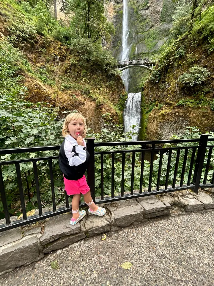 Juni standing in front of Multnomah Falls